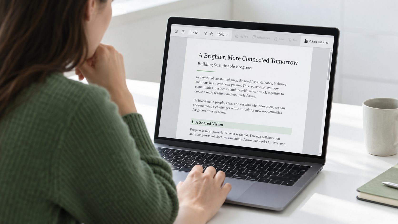 A person reading a secured PDF on a laptop, with the highlight and comment controls visibly disabled